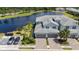 Aerial view of townhomes with lake view featuring private garages, paver driveways and professional landscaping at 14617 Sycamore Ct # 2211, Punta Gorda, FL 33955