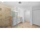 Modern bathroom featuring a glass-enclosed shower, granite countertops, and white cabinetry at 14617 Sycamore Ct # 2211, Punta Gorda, FL 33955