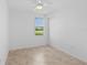 Bright bedroom with ceiling fan and window view of outdoors at 14617 Sycamore Ct # 2211, Punta Gorda, FL 33955