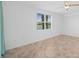 Bright bedroom with a ceiling fan, lake view, and large window at 14617 Sycamore Ct # 2211, Punta Gorda, FL 33955