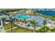 Aerial view of the community pool with lounge chairs and palm trees at 14617 Sycamore Ct # 2211, Punta Gorda, FL 33955