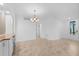 Open concept dining area with tile floors, chandelier and bright natural light at 14617 Sycamore Ct # 2211, Punta Gorda, FL 33955