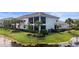 Home exterior featuring a screened in patio with lush landscaping and a pond at 14617 Sycamore Ct # 2211, Punta Gorda, FL 33955
