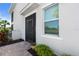 Exterior view showing a screened-in front porch, a window, and some lovely landscaping at 14617 Sycamore Ct # 2211, Punta Gorda, FL 33955