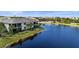 Home with a large lake on the back, a screened lanai, and lush landscaping at 14617 Sycamore Ct # 2211, Punta Gorda, FL 33955