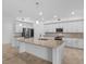 Spacious kitchen features a large island with granite countertops, stainless steel appliances, and white cabinetry at 14617 Sycamore Ct # 2211, Punta Gorda, FL 33955