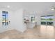 Bright open kitchen featuring an island, tile floors, stainless appliances and a view of the lake at 14617 Sycamore Ct # 2211, Punta Gorda, FL 33955