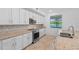 Bright kitchen with stainless steel appliances, granite countertops, and a view of the water at 14617 Sycamore Ct # 2211, Punta Gorda, FL 33955