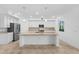 Well-lit kitchen featuring stainless appliances and a spacious granite island with pendant lighting at 14617 Sycamore Ct # 2211, Punta Gorda, FL 33955
