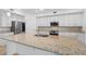 Close up of a modern kitchen island featuring granite countertops, stainless steel appliances, and tile floors at 14617 Sycamore Ct # 2211, Punta Gorda, FL 33955