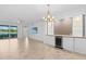 Bright living room featuring custom bar with wine cooler and sliding glass doors to lanai at 14617 Sycamore Ct # 2211, Punta Gorda, FL 33955