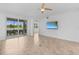 Bright living room featuring a ceiling fan, tile floors, TV, and a view of the lake from the screened-in patio at 14617 Sycamore Ct # 2211, Punta Gorda, FL 33955