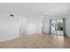 Open living room with tile flooring, ceiling fan, and sliding glass doors leading to the lanai at 14617 Sycamore Ct # 2211, Punta Gorda, FL 33955