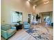 An elegant lobby space with comfortable seating, modern artwork, and views of the landscaped exterior at 14617 Sycamore Ct # 2211, Punta Gorda, FL 33955