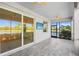 Screened patio with ceiling fans, TV, and a pond view at 14617 Sycamore Ct # 2211, Punta Gorda, FL 33955