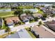 An aerial view displays a well-maintained home near a picturesque pond, highlighting its desirable location and community charm at 1872 Birmingham Blvd, Port Charlotte, FL 33980