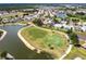 Aerial view of the community, golf course, lake, and the home's location in a vibrant neighborhood at 1872 Birmingham Blvd, Port Charlotte, FL 33980