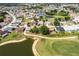 Aerial view of the golf course community with lakes, mature trees and vibrant landscaping at 1872 Birmingham Blvd, Port Charlotte, FL 33980