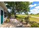 Beautiful golf course view from the backyard of this home, green grass, landscaping, and a brick walkway at 1872 Birmingham Blvd, Port Charlotte, FL 33980