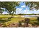 Beautiful lake and golf course views from the back of this home's lushly landscaped backyard at 1872 Birmingham Blvd, Port Charlotte, FL 33980