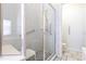 A bright bathroom features a walk-in shower with glass enclosure, a bench seat, and handrails at 1872 Birmingham Blvd, Port Charlotte, FL 33980
