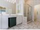 This bathroom features a double vanity, walk-in shower with glass enclosure, and floral wallpaper at 1872 Birmingham Blvd, Port Charlotte, FL 33980