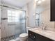 This bathroom offers a sleek vanity with marble countertop and glass shower with mosaic tile accents at 1872 Birmingham Blvd, Port Charlotte, FL 33980