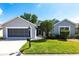 Charming single-story home featuring a manicured lawn, screened garage, and well-kept landscaping at 1872 Birmingham Blvd, Port Charlotte, FL 33980