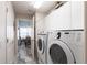 A well-equipped laundry room with washer, dryer, storage, and access to the dining area at 1872 Birmingham Blvd, Port Charlotte, FL 33980