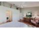 A bright main bedroom features a ceiling fan, neutral walls, and a classic dresser with television at 1872 Birmingham Blvd, Port Charlotte, FL 33980