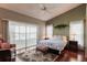Comfortable main bedroom with hardwood floors, natural light, and a sliding glass door to the outside patio at 1872 Birmingham Blvd, Port Charlotte, FL 33980