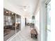 Bright sunroom with white tile floors, ceiling fan and plenty of sunlight and multiple access doors at 1872 Birmingham Blvd, Port Charlotte, FL 33980
