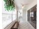 Bright sunroom with white tile floors, ceiling fan, lots of windows and access to other rooms at 1872 Birmingham Blvd, Port Charlotte, FL 33980