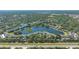 Aerial view of community, highlighting the central lake, mature trees and residential buildings at 19325 Water Oak Dr # 305, Port Charlotte, FL 33948
