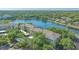 A panoramic view of the condo building surrounded by a lake and lush greenery at 19325 Water Oak Dr # 305, Port Charlotte, FL 33948