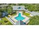 Aerial view showcasing the geometric design of a community pool surrounded by lush landscaping at 19325 Water Oak Dr # 305, Port Charlotte, FL 33948
