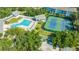 Aerial view of community amenities including a pool, clubhouse, tennis court, and bocce court at 19325 Water Oak Dr # 305, Port Charlotte, FL 33948