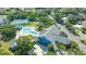 Aerial view showcases the community pool, clubhouse, tennis courts, and lush landscaping at 19325 Water Oak Dr # 305, Port Charlotte, FL 33948