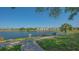 View of lake and sidewalk in the backyard at 19325 Water Oak Dr # 305, Port Charlotte, FL 33948