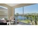 Serene screened balcony with comfortable seating offering picturesque views of the lake at 19325 Water Oak Dr # 305, Port Charlotte, FL 33948