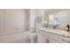 Bright bathroom featuring a tub with shower, a marble countertop vanity, and modern fixtures at 19325 Water Oak Dr # 305, Port Charlotte, FL 33948