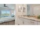 Bright bathroom with double sinks, granite countertops, and neutral decor adjacent to the bedroom at 19325 Water Oak Dr # 305, Port Charlotte, FL 33948