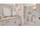 Clean bathroom with a double sink vanity, a flamingo artwork and a tiled shower/tub at 19325 Water Oak Dr # 305, Port Charlotte, FL 33948