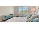 Comfortable bedroom boasts a large window, stylish decor, and a cozy bench at 19325 Water Oak Dr # 305, Port Charlotte, FL 33948