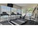 Bright exercise room features treadmills and workout equipment with large windows and natural light at 19325 Water Oak Dr # 305, Port Charlotte, FL 33948