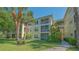 Exterior shot of the condominium, featuring balconies, lush landscaping, and well-maintained grounds at 19325 Water Oak Dr # 305, Port Charlotte, FL 33948