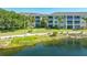 A view of the condominium overlooks the community pond and lush green grass at 19325 Water Oak Dr # 305, Port Charlotte, FL 33948
