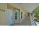Hallway shot featuring unit 305, white door, and bright outdoor lighting at 19325 Water Oak Dr # 305, Port Charlotte, FL 33948