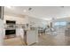 Open-concept kitchen/living room with stainless steel appliances and balcony access at 19325 Water Oak Dr # 305, Port Charlotte, FL 33948