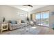 Cozy living room features a comfortable sofa, stylish decor, and sliding doors to balcony at 19325 Water Oak Dr # 305, Port Charlotte, FL 33948